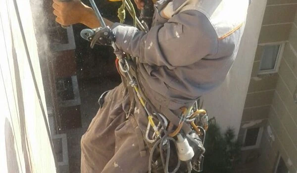 در حال پیچ ورولپلاک زدن سنگ نما با دریل مخصوص